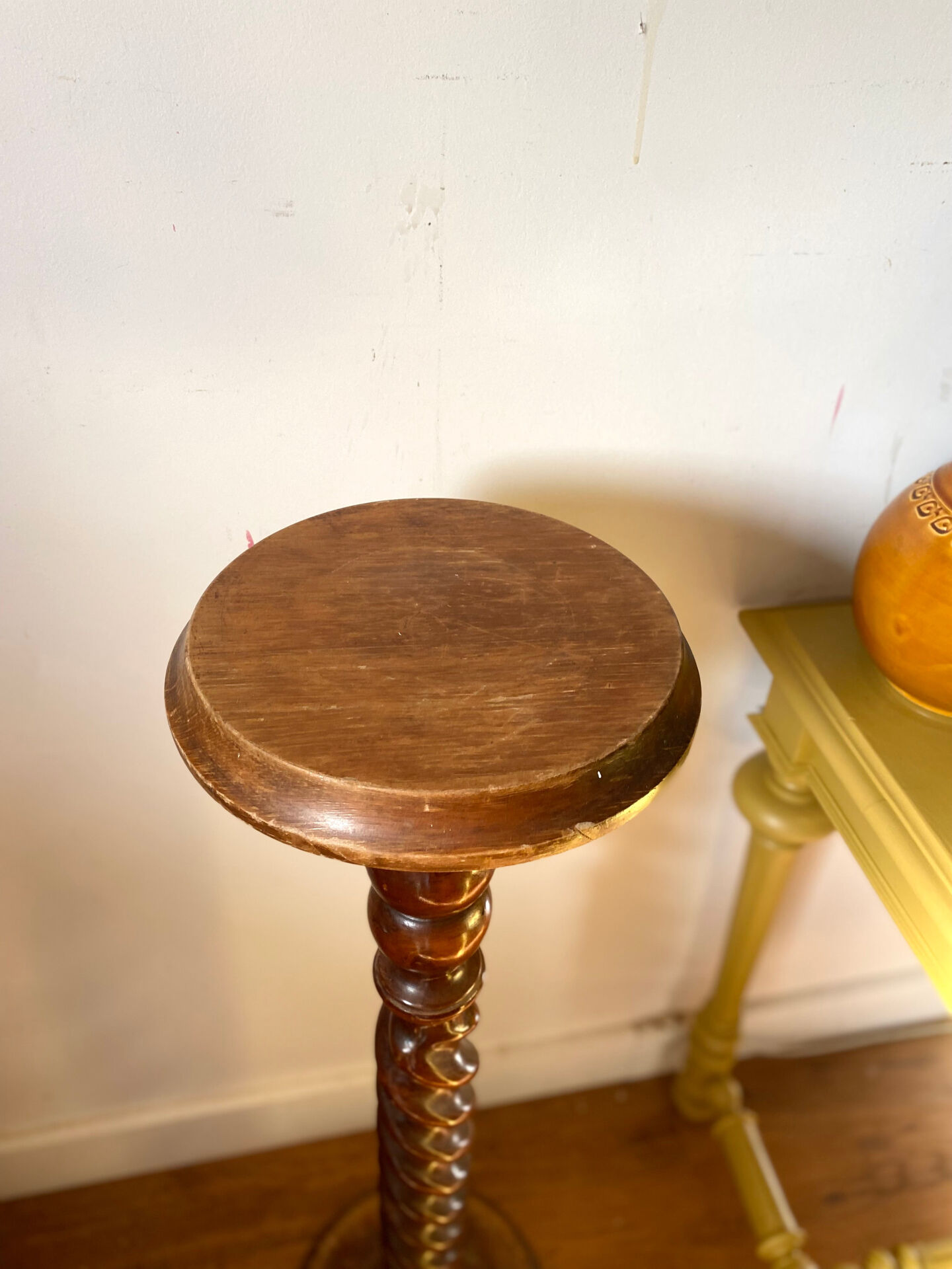 Antique pedestal table with a twisted column.