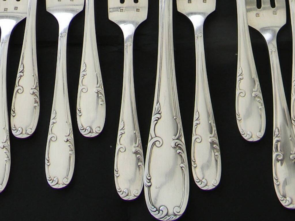 12 cake forks and a silver metal server.