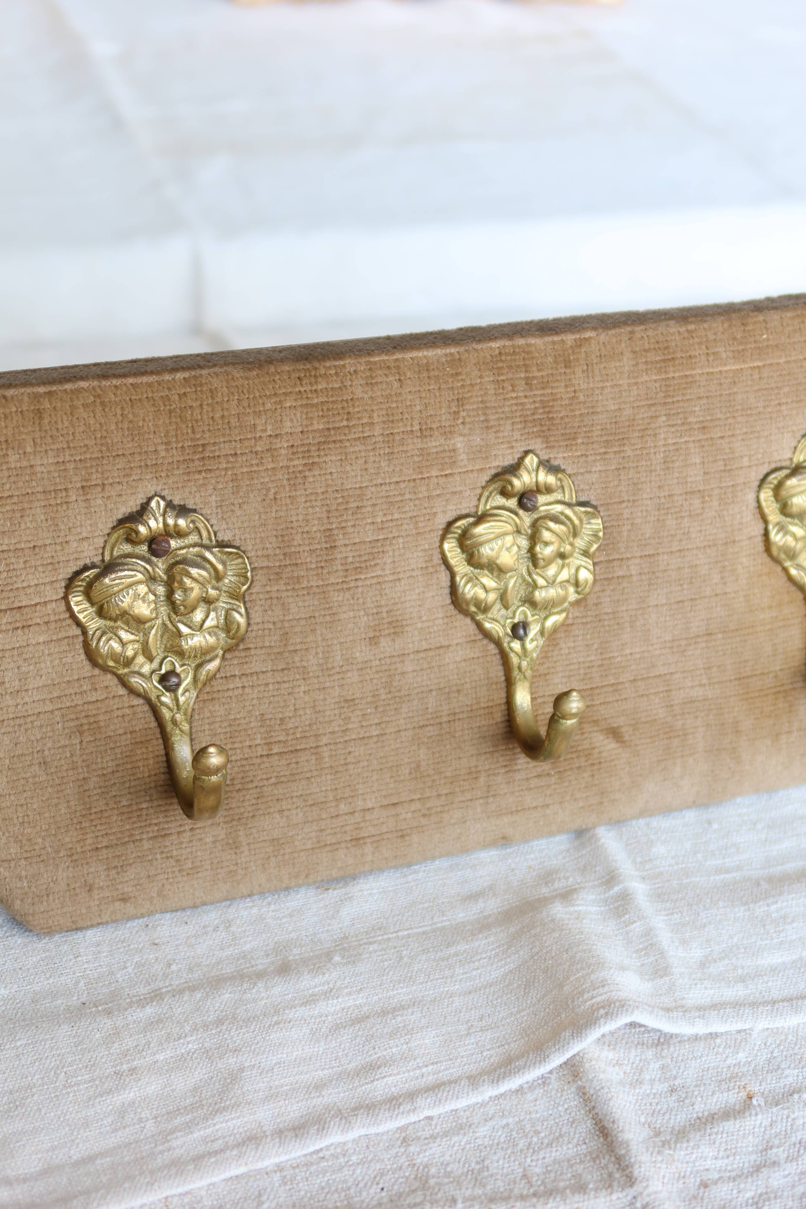 Vintage velvet coat rack with brass hooks