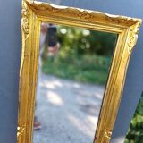 narrow gilded mirror in Louis XV style