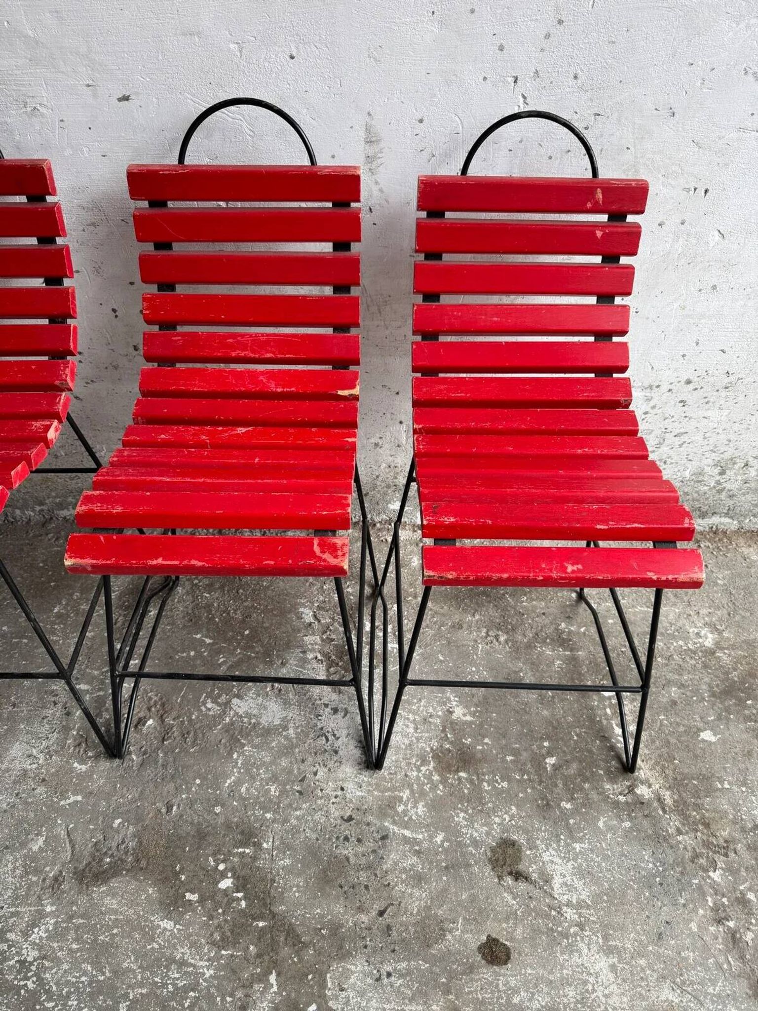 Red slatted chair with a black metal frame.