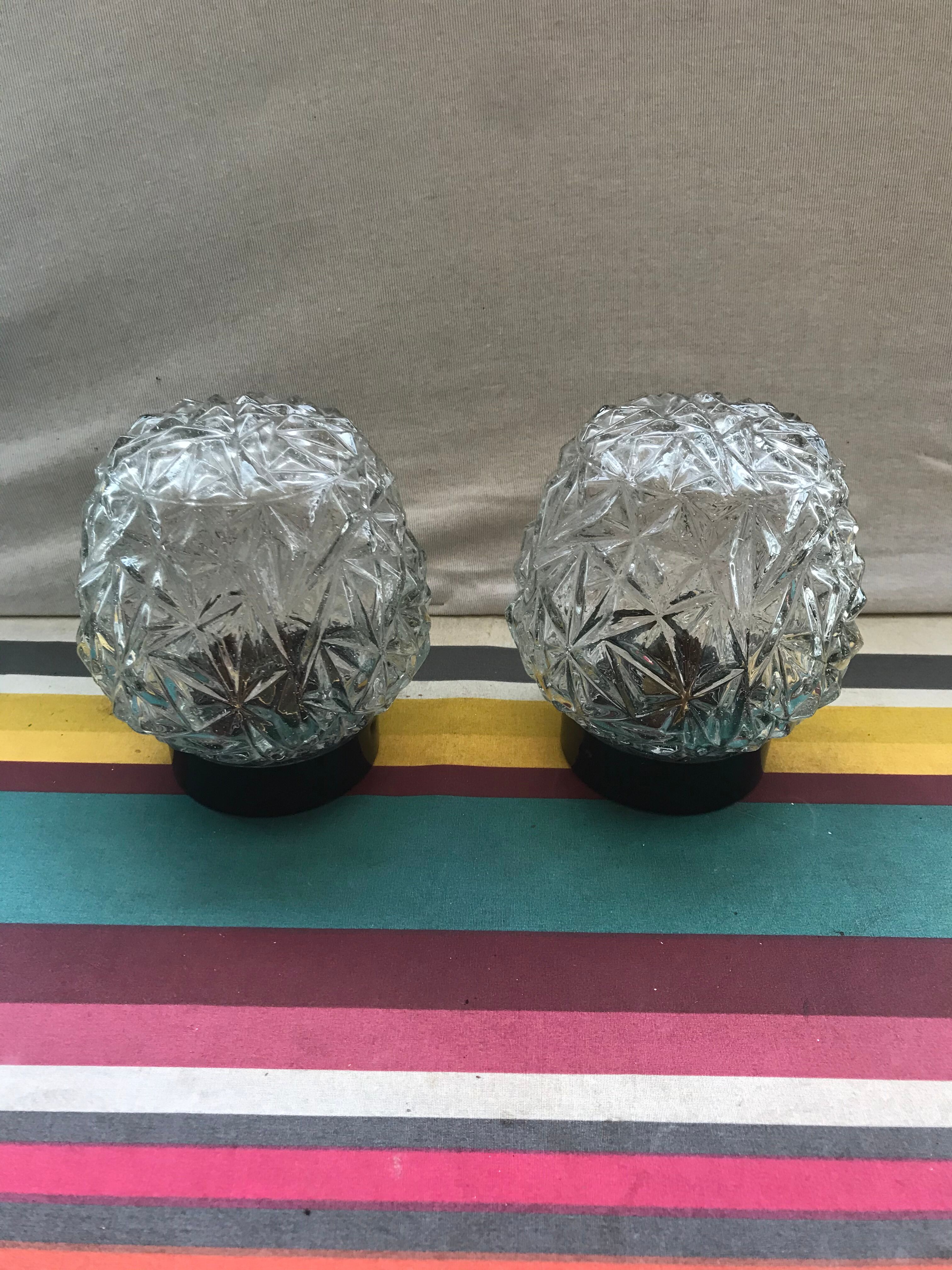 Old pair of glass moulded wall sconces with vintage black metal support