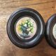 Set of three miniature flowers in a vase.