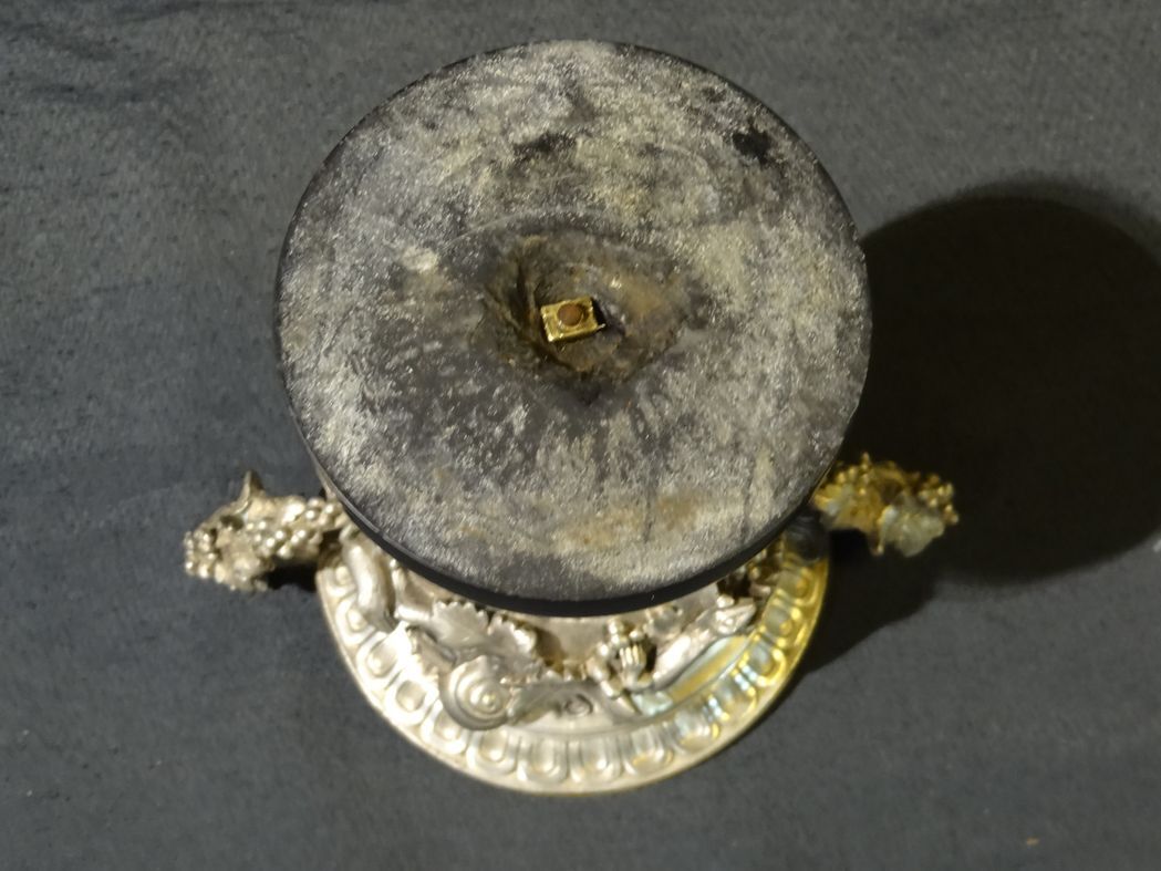 Carved silver bronze vase mounted on marble pedestal