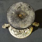 Carved silver bronze vase mounted on marble pedestal