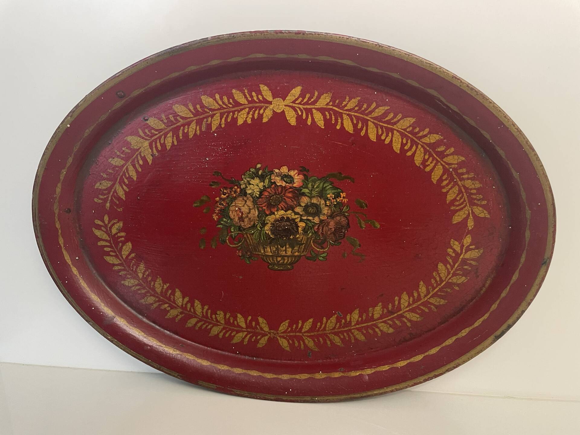 Old oval plate in painted red tin - floral decoration - early 20th century -