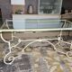 Wrought iron table by Roche Bobois, with a glass top.