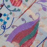 White suzani kilim rug with embroidered colorful patterns