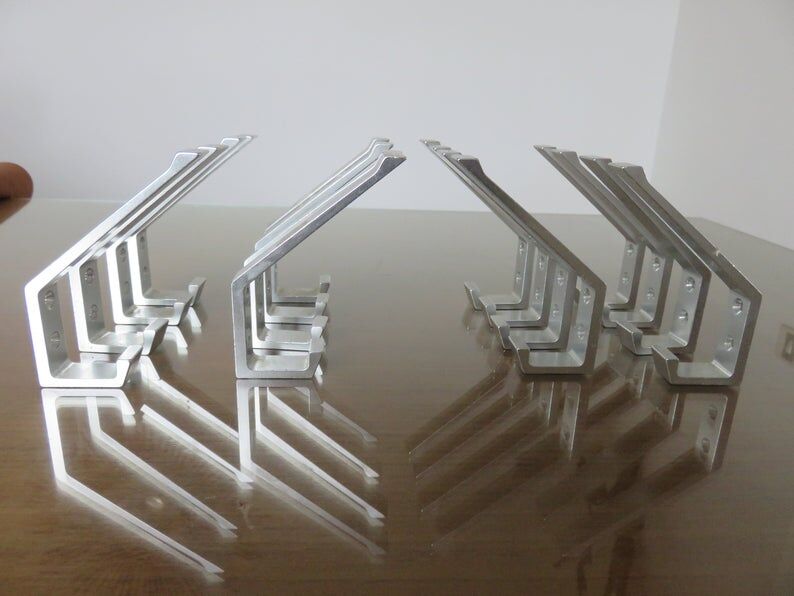 Series of 16 70s aluminium pads