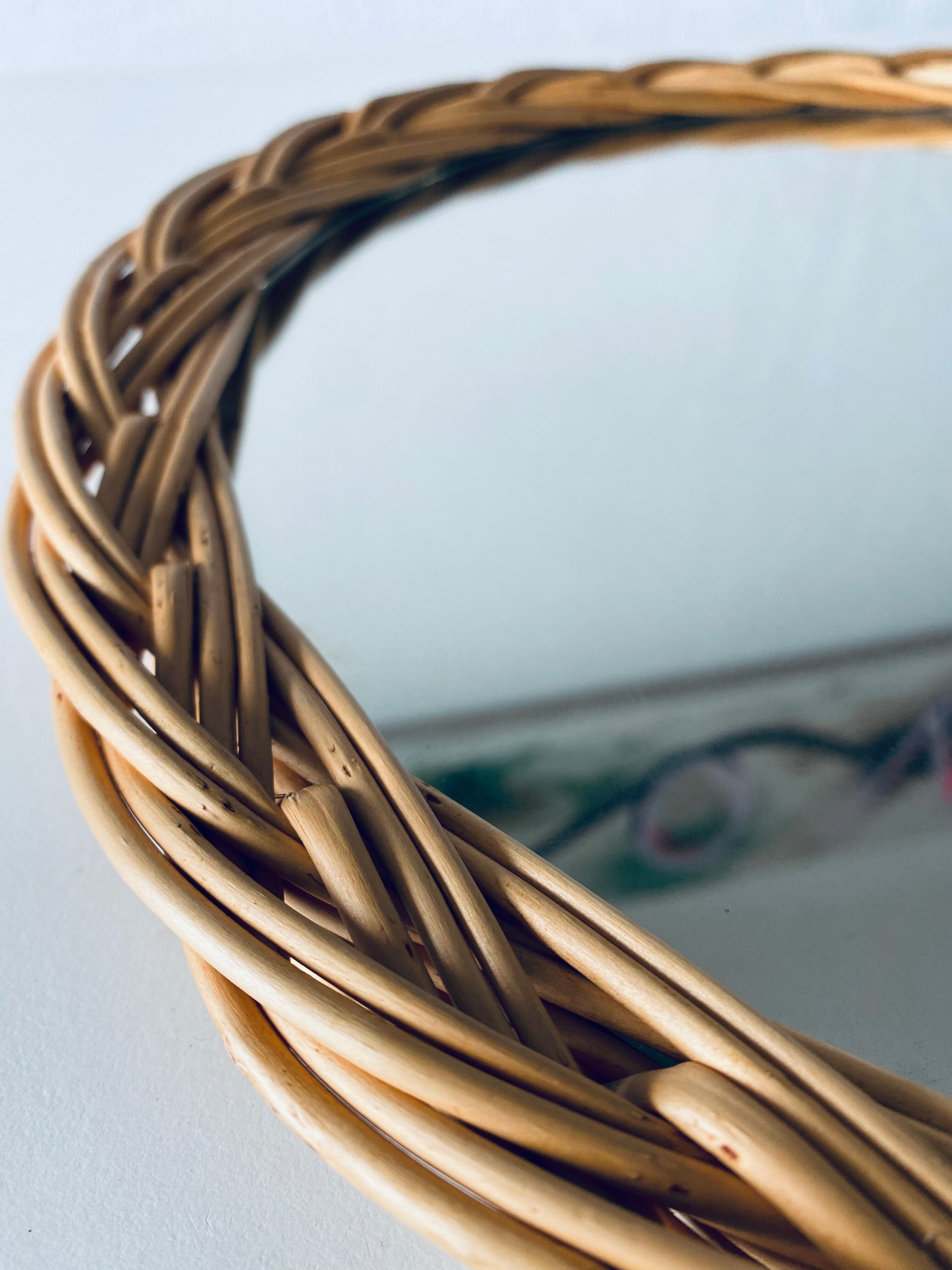 Round mirror in vintage wicker