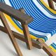 Vintage deck chair with blue and yellow striped fabric, original patina.