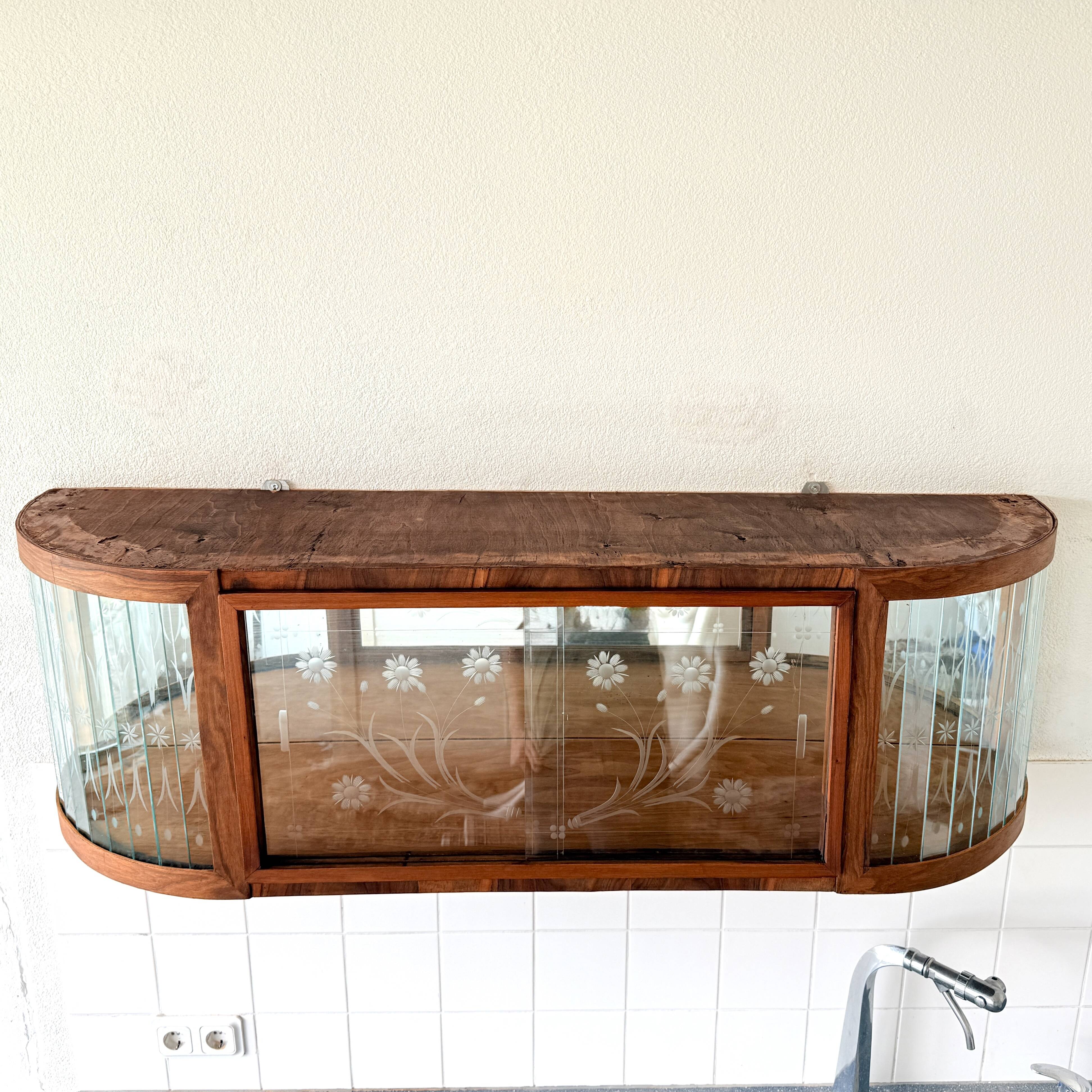 Art Deco-style wall-mounted display cabinet with floral engraving