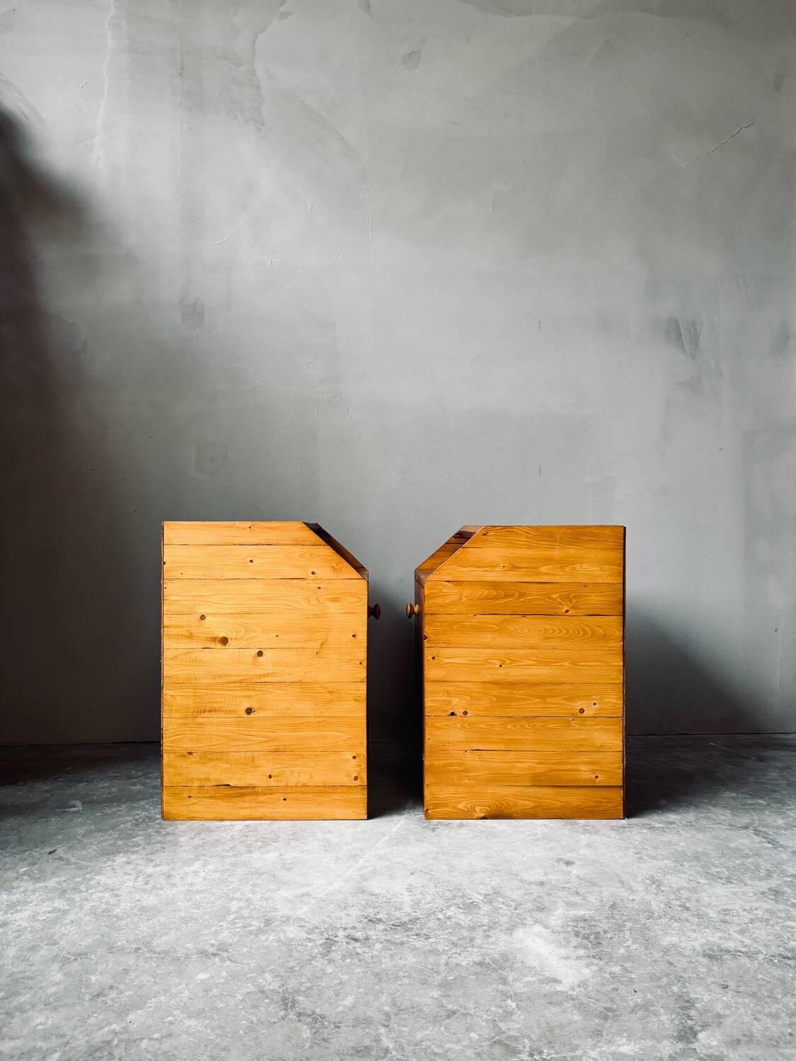 Pair of handcrafted solid wood bedside tables with drop-down doors.