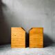 Pair of handcrafted solid wood bedside tables with drop-down doors.