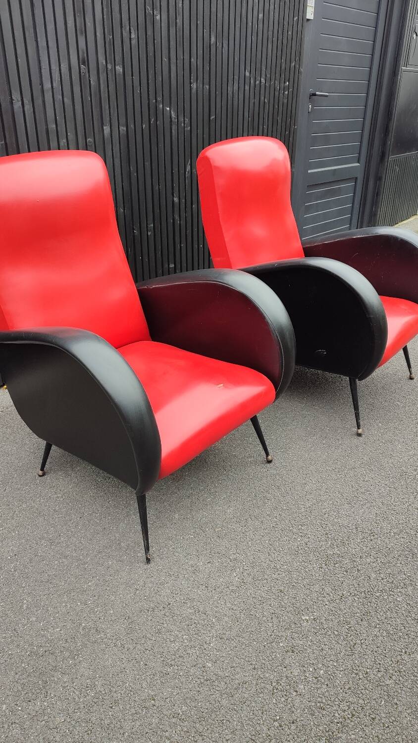 Pair of red and black faux leather armchairs