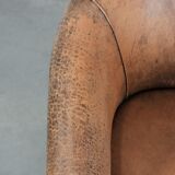 Vintage sheepskin club armchair with character and a beautiful patina