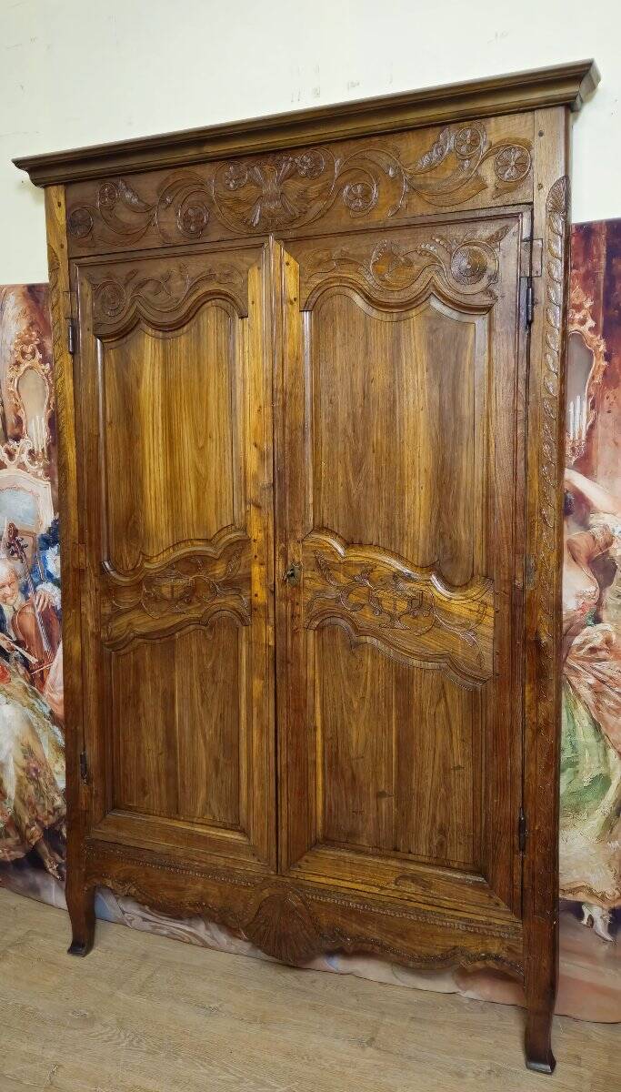 Louis XV period wardrobe façade, solid wood architectural elements, richly carved.