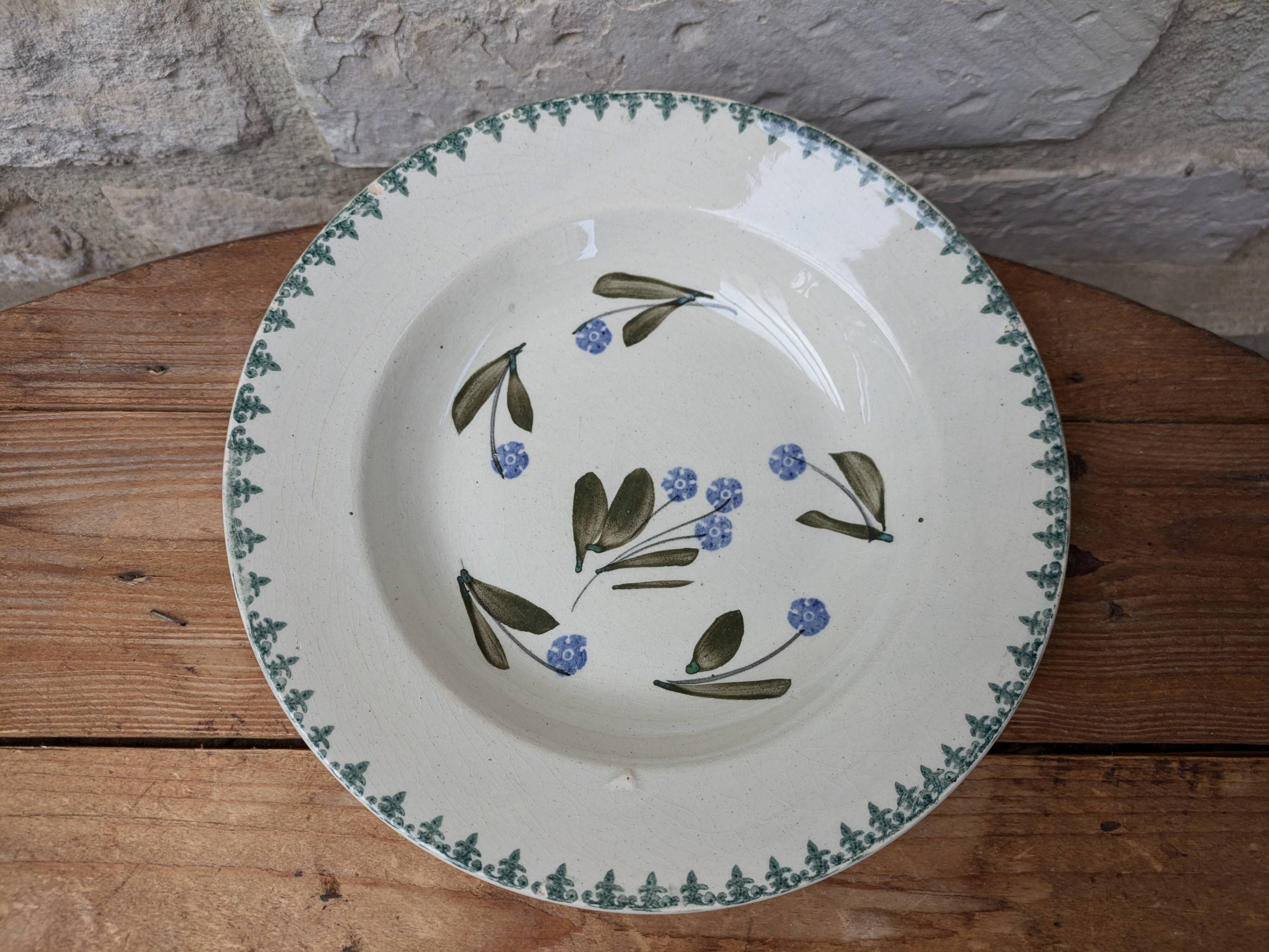 Old deep iron earth plate with blue flower pattern