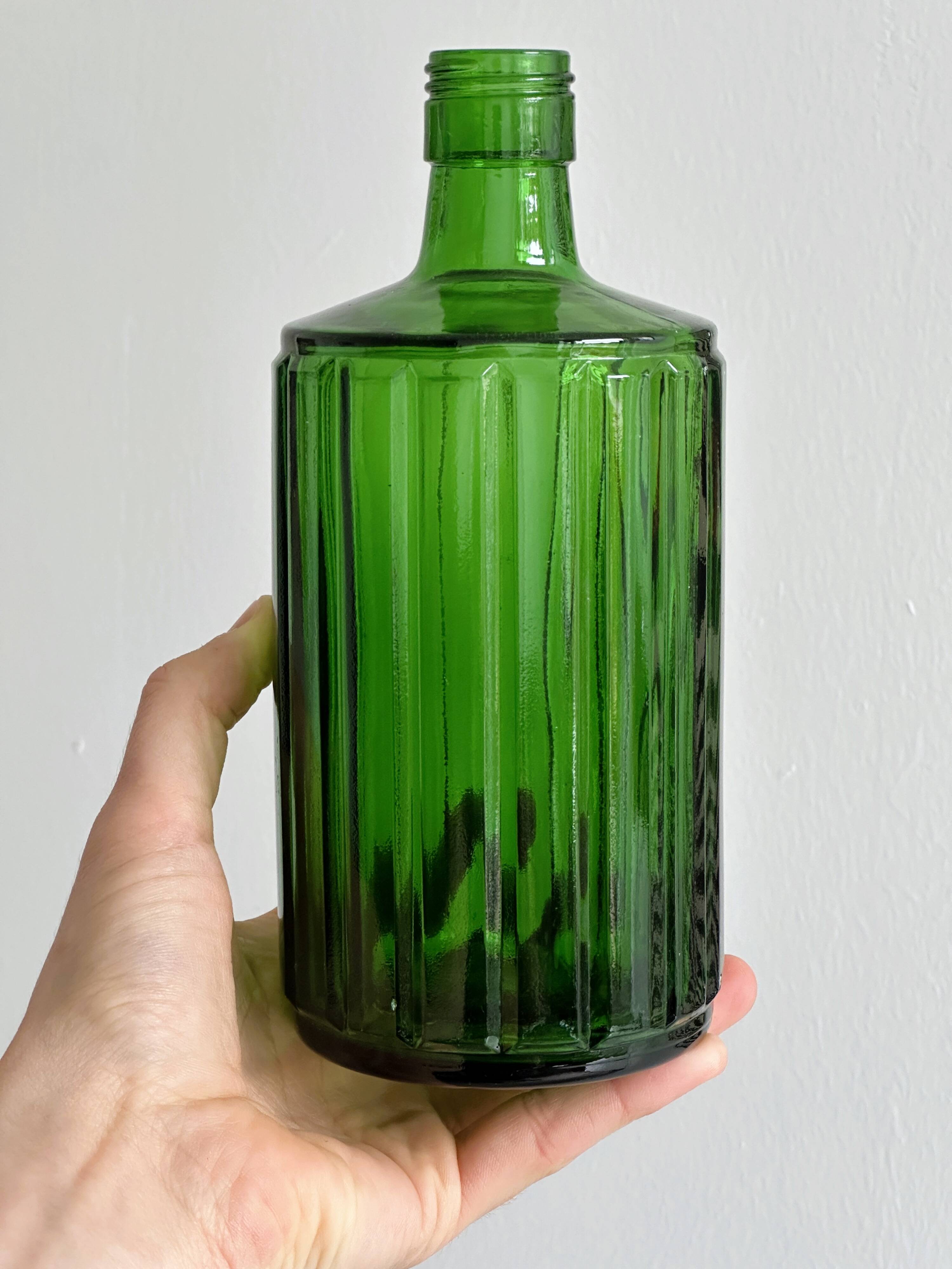 Green glass bottle, ribbed design.