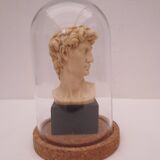 Small glass globe on base housing a figurine of “david”