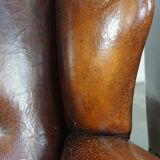 Set of 2 sheep leather wingback chairs with red corduroy seat cushions