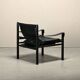 Fauteuil de salon Sirocco Safari Arne Norell en cuir noir et frêne teinté.