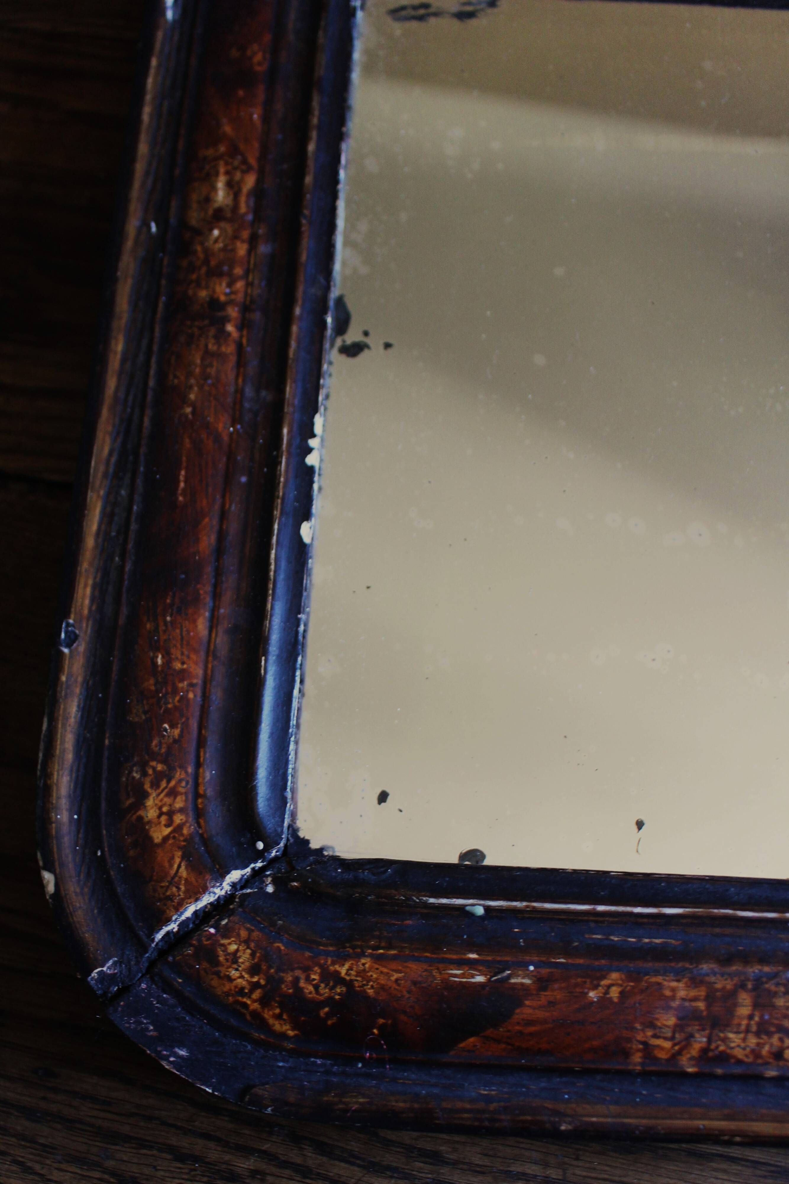 Antique Louis Philippe mirror in black and brown.