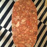 Piece of terracotta color marble sofa