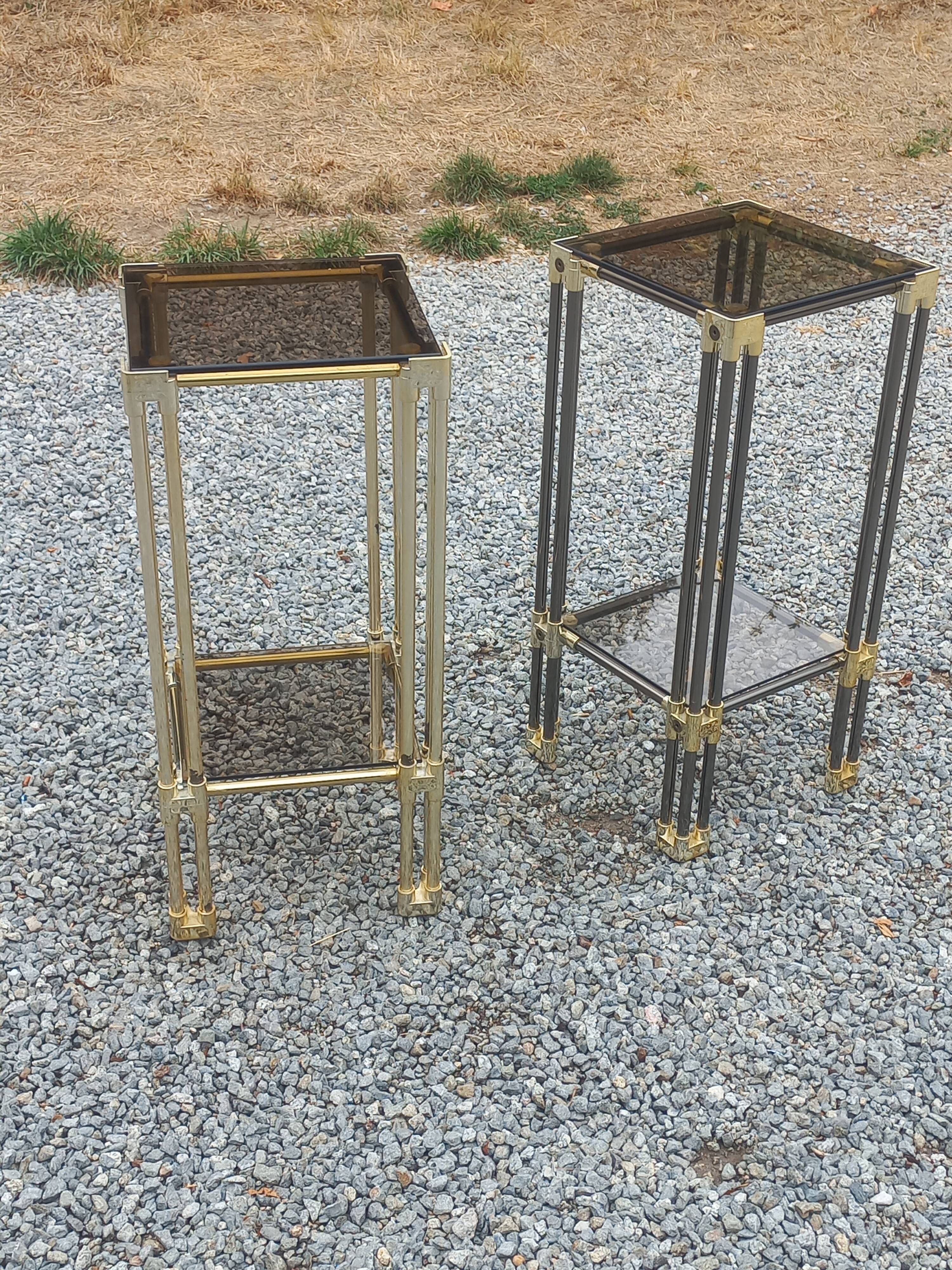 Pair of Hollywood Regency side tables in gold metal and smoked glass.