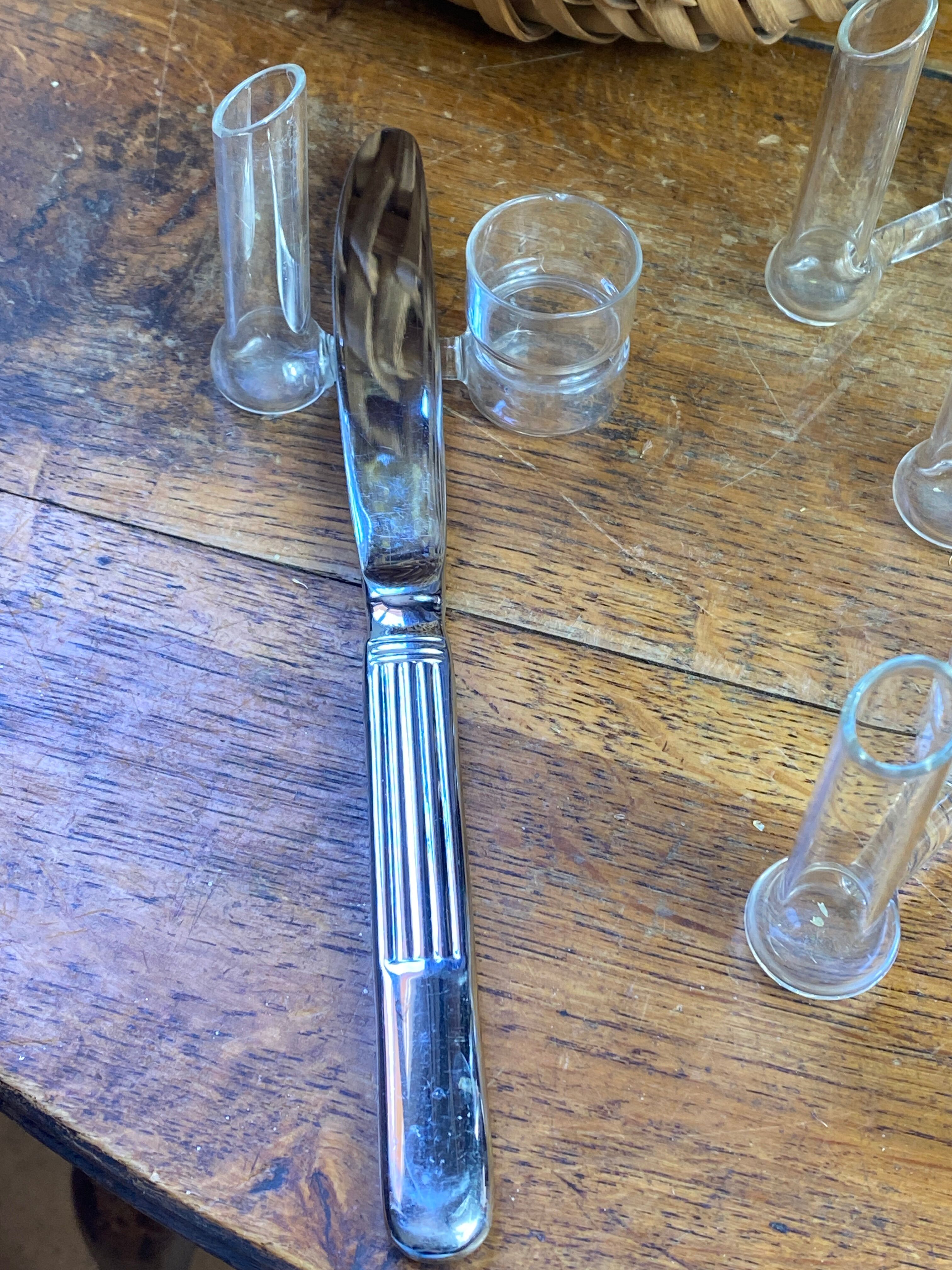 Knife rests, flower vases and candle holders in blown glass.