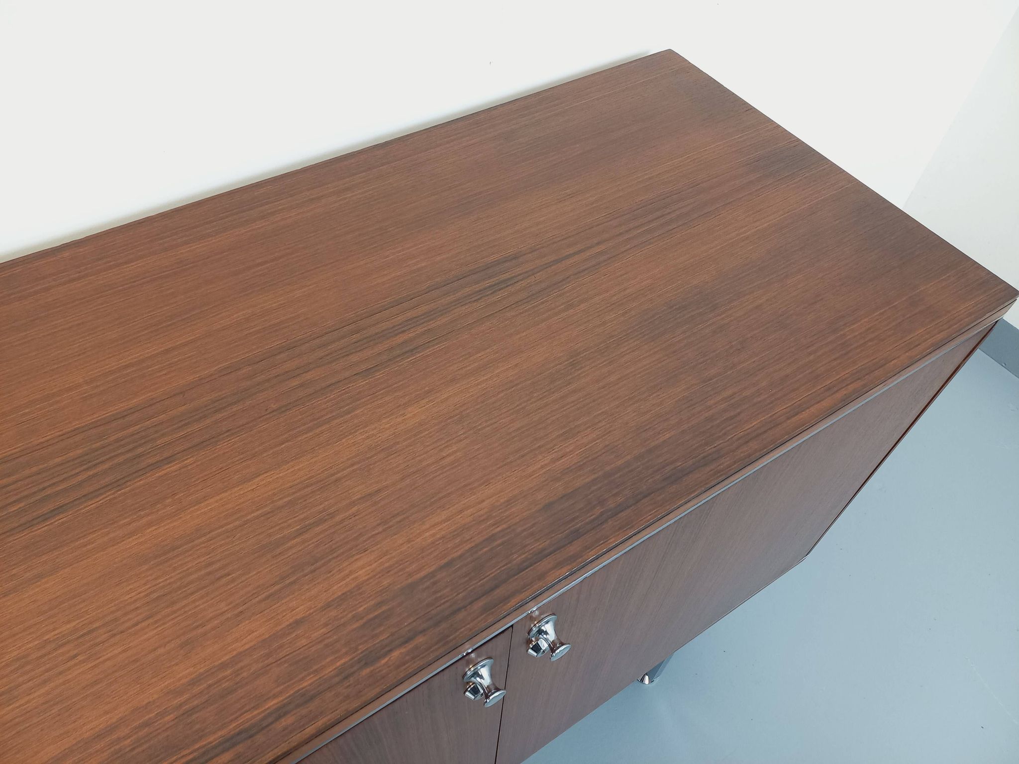 Vintage modernist enfilade in rosewood and chrome metal from the 60s and 70s.