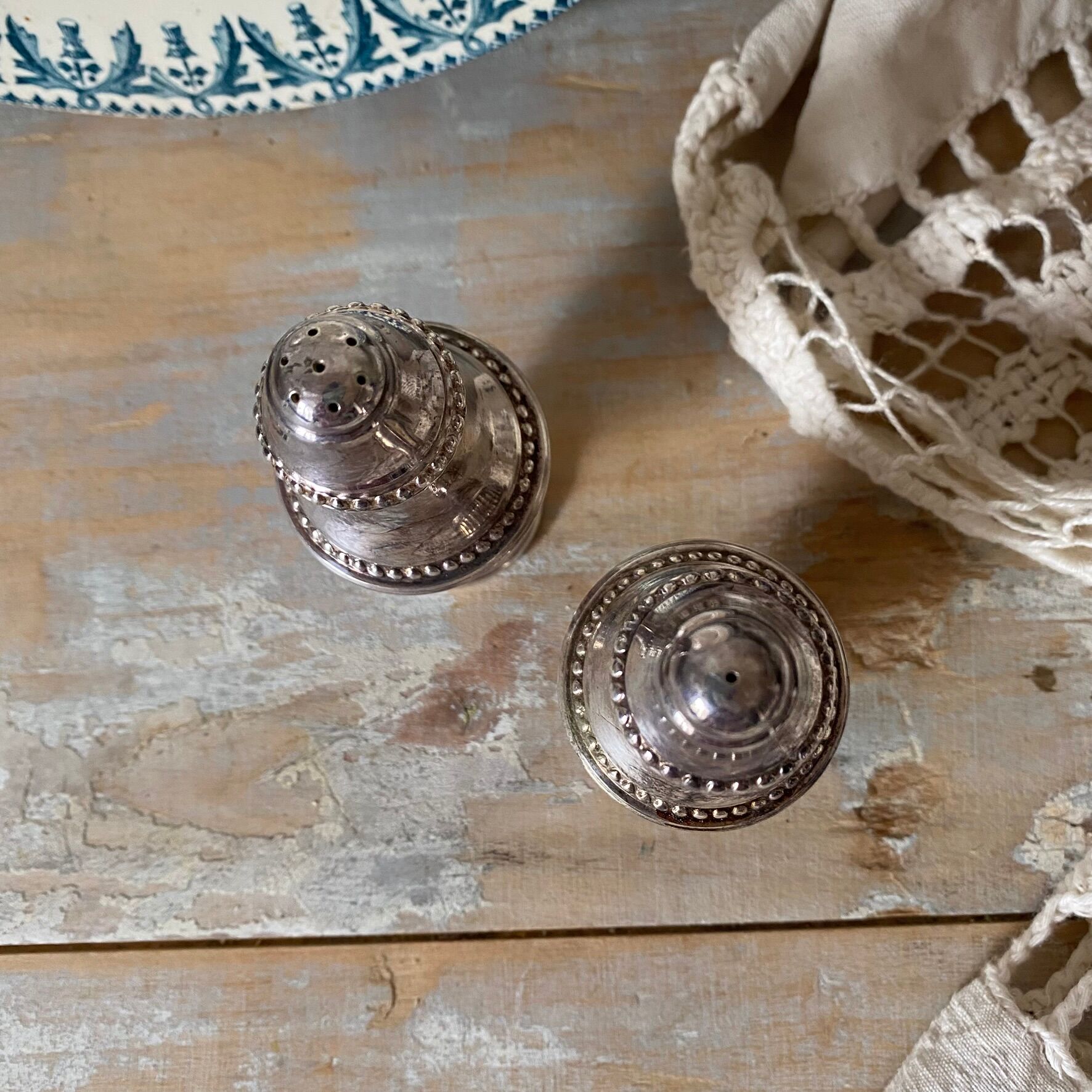 Silver-plated salt and pepper shakers, fluted, beaded decoration.