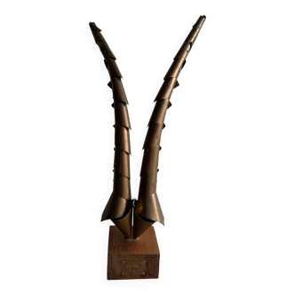 Golden brass sculptural horns on wooden base — modern metal art sculpture, 68.5 cm high