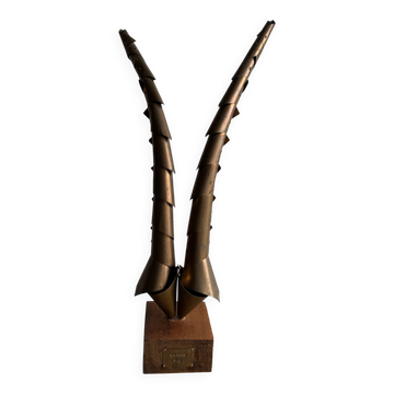 Golden brass sculptural horns on wooden base — modern metal art sculpture, 68.5 cm high