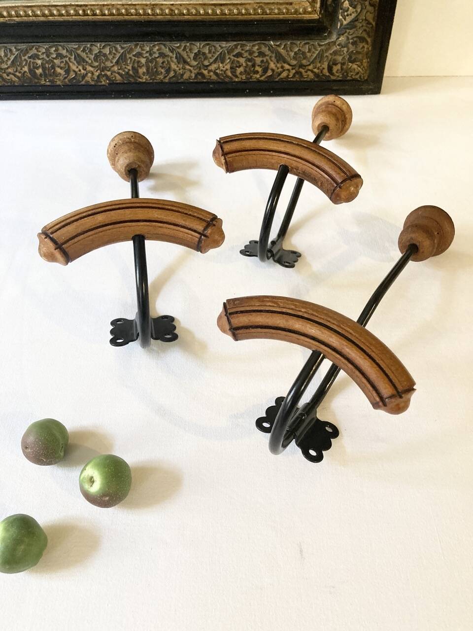 Trio of antique wooden and metal coat hooks