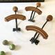 Trio of antique wooden and metal coat hooks