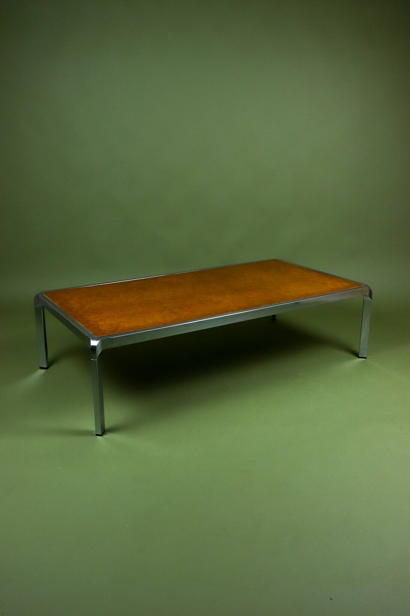 Vintage 1970s coffee table in chrome and burl wood.
