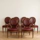 Set of 6 Louis XVI style medallion chairs and armchairs in burgundy leather.