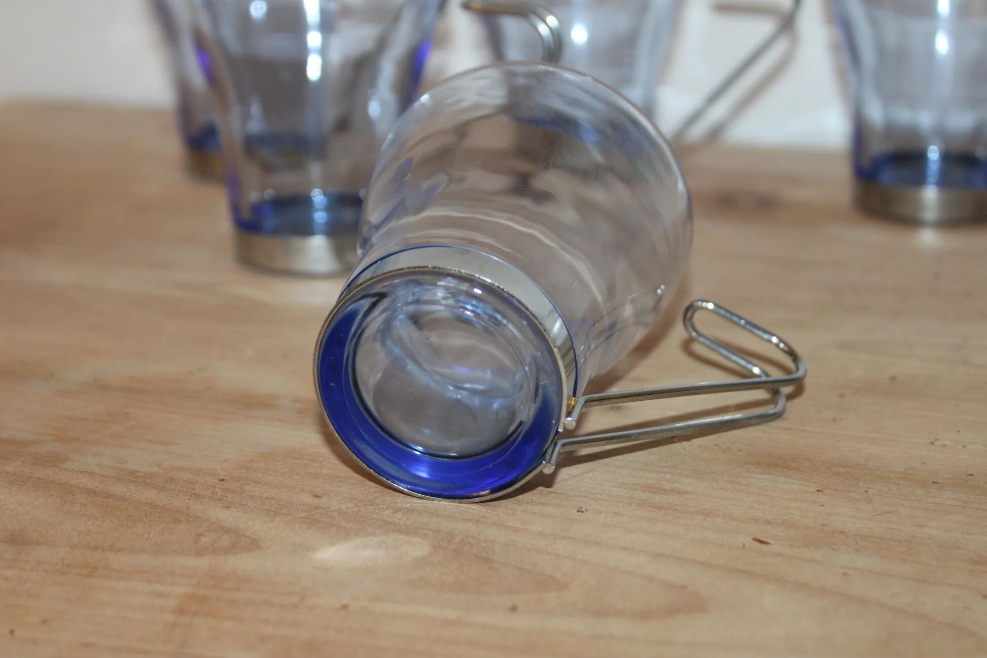 Set of 5 vintage blue-tinted glass cups with metal holders.