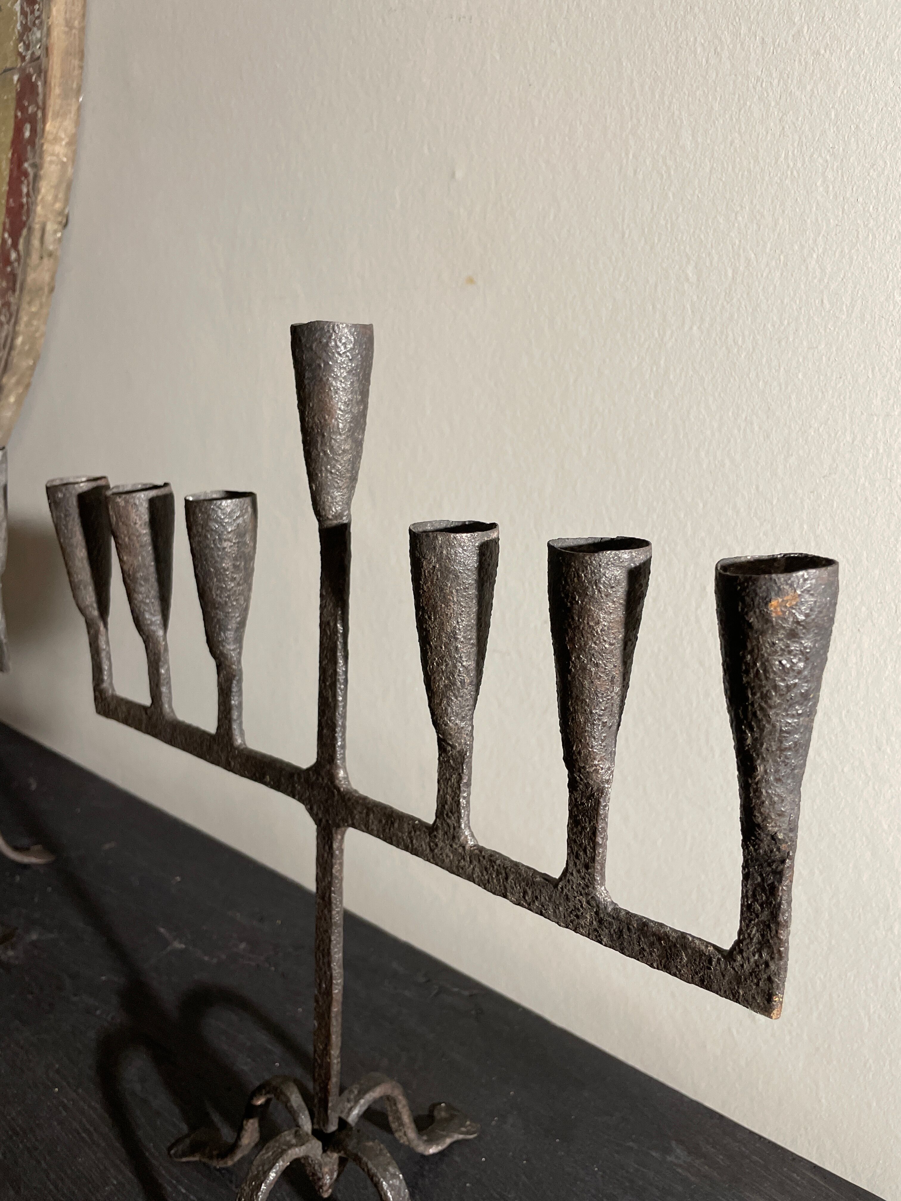 Pair of beaten iron candlesticks