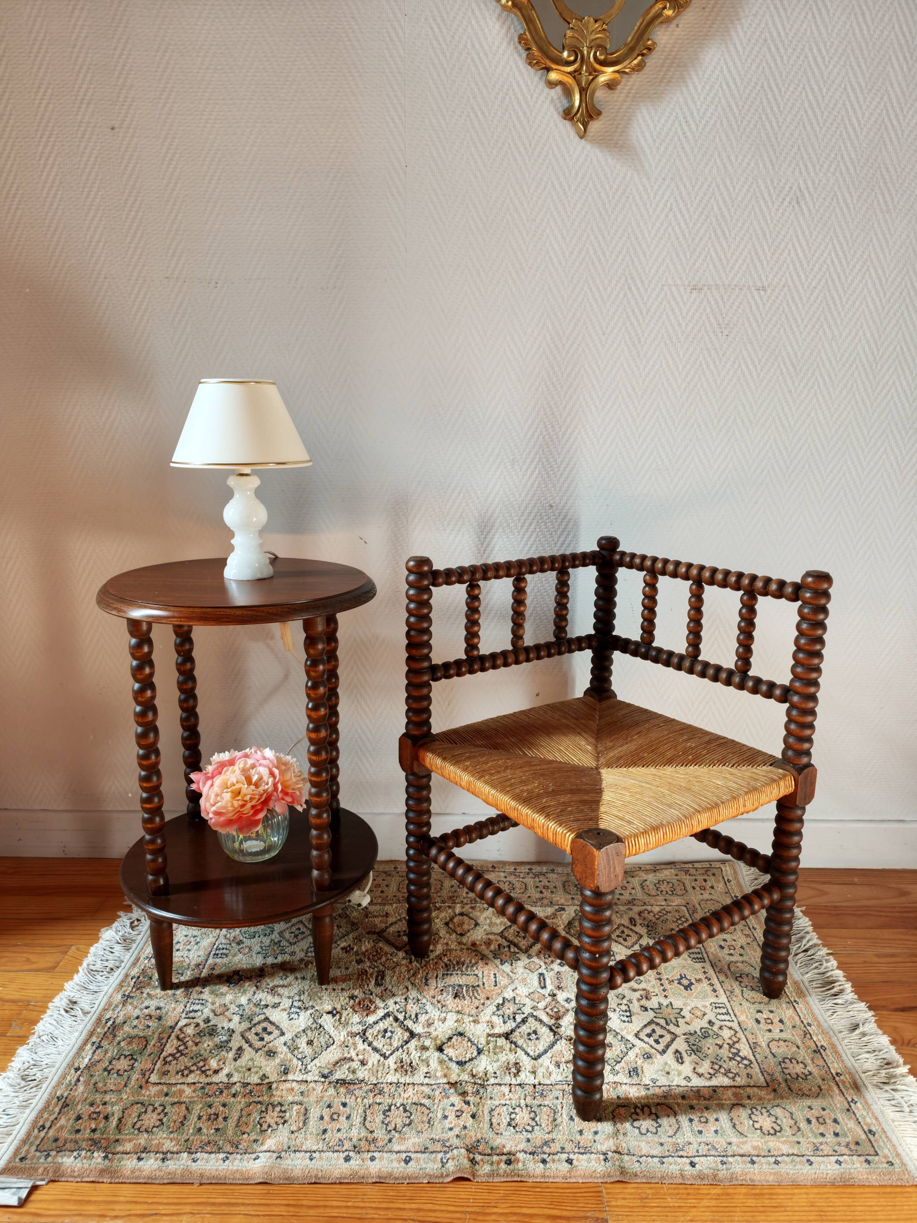 Old wooden turned spindle fireside chair with a straw seat.