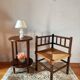 Old wooden turned spindle fireside chair with a straw seat.