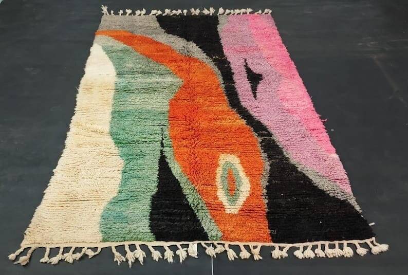 Large handmade Moroccan rug with colourful patterns.