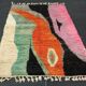 Large handmade Moroccan rug with colourful patterns.