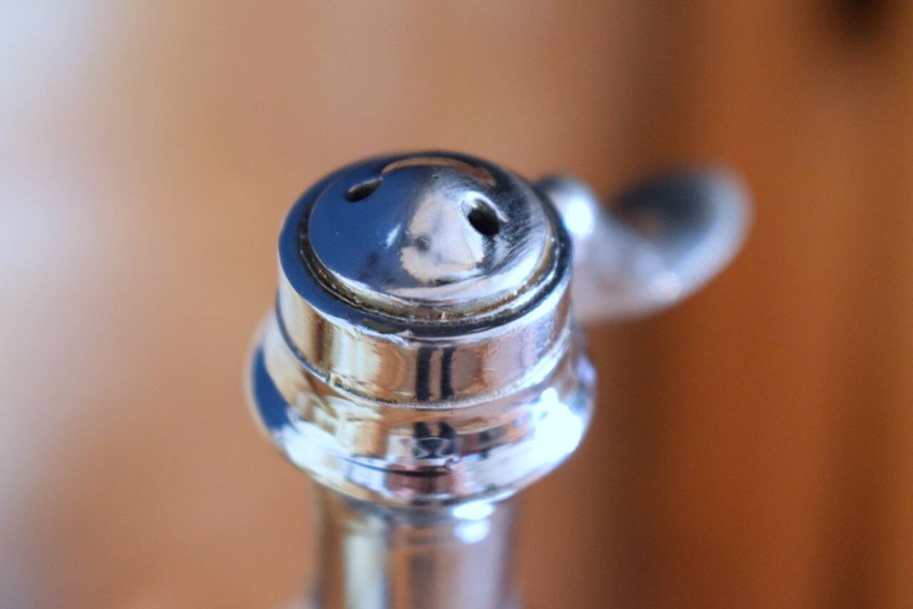 Silver metal siphon.
