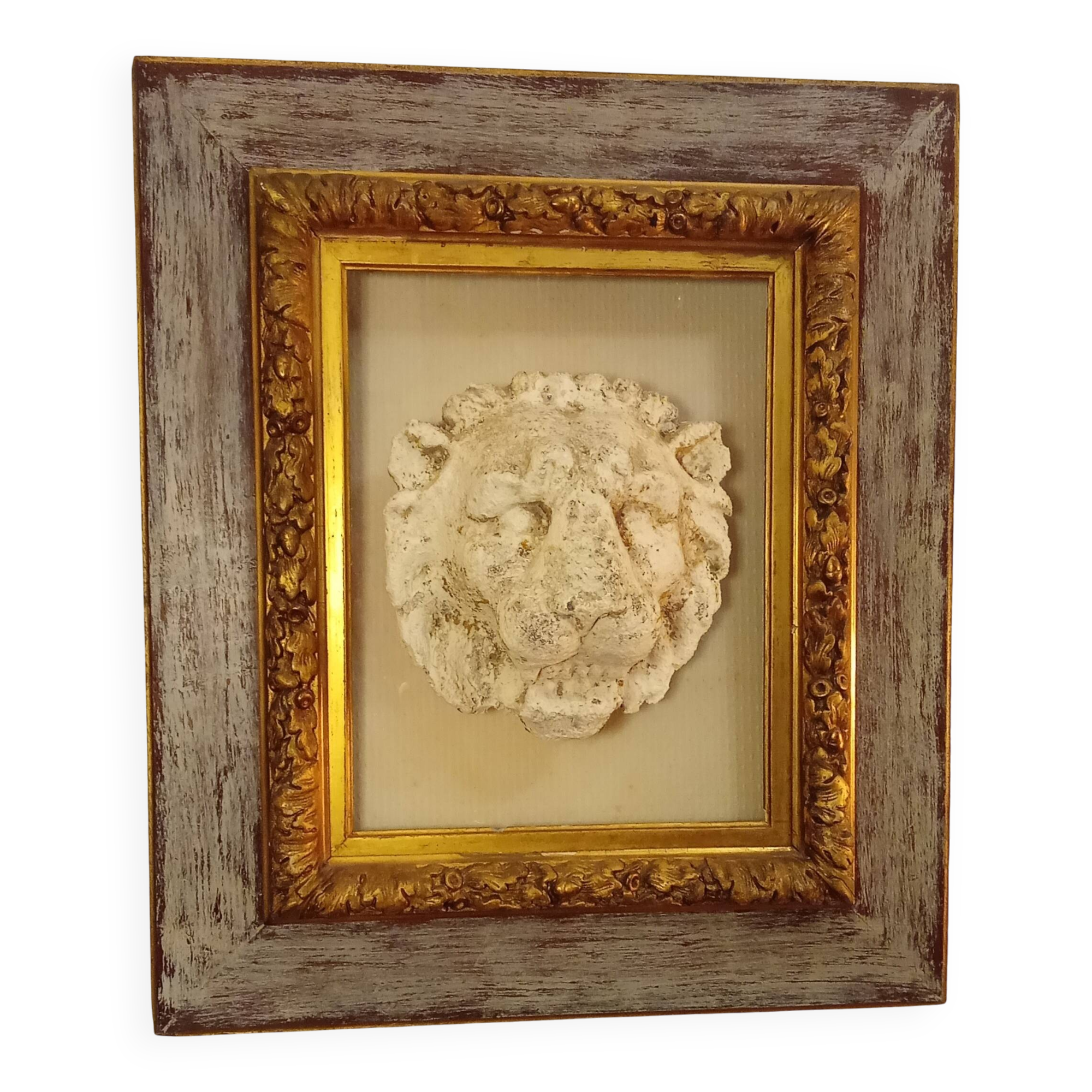 Antique gilded frame with stone lion head ornament on plexiglass