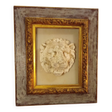 Antique gilded frame with stone lion head ornament on plexiglass