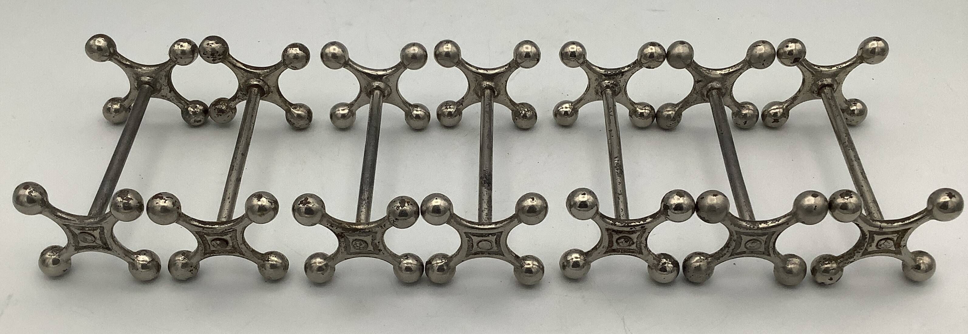 Set of 7 vintage knife rests in the shape of crosses in silver-plated metal.