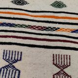 White carpet with multicolored Berber patterns woven hands