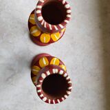 A pair of glazed earthenware candlesticks.